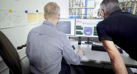 Men in front of a simulation